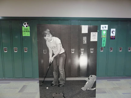 “In the junior’s putt-putt tournament, junior Laura Schlensker takes her shot at the Pokemon hole. The money raised was donated to the Make a Wish Foundation. The event took place in the hallways of the school” 