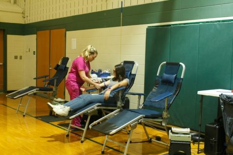 Emma Russom, junior, donates blood.