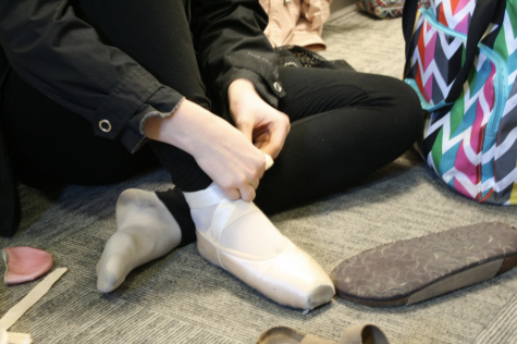 Elizabeth Arnold, 9, laces her pointe shoes.
Photo by Kylie Heagy